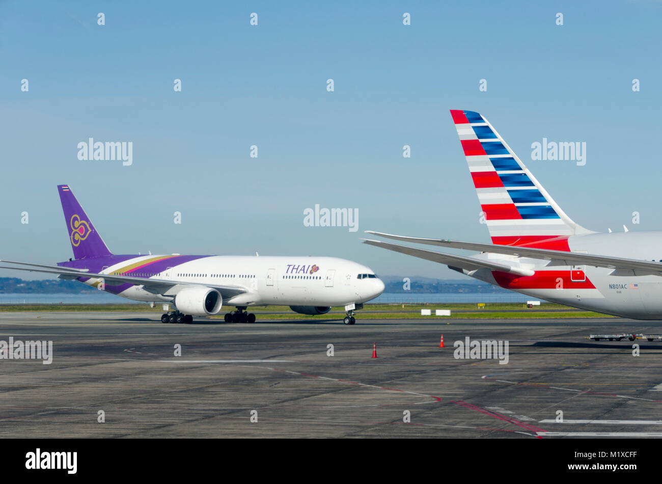 Thai Airways Boeing 777 and American AIrlines Boeing 787 Dreamliner at Auckland Airport, New Zealand Stock Photo