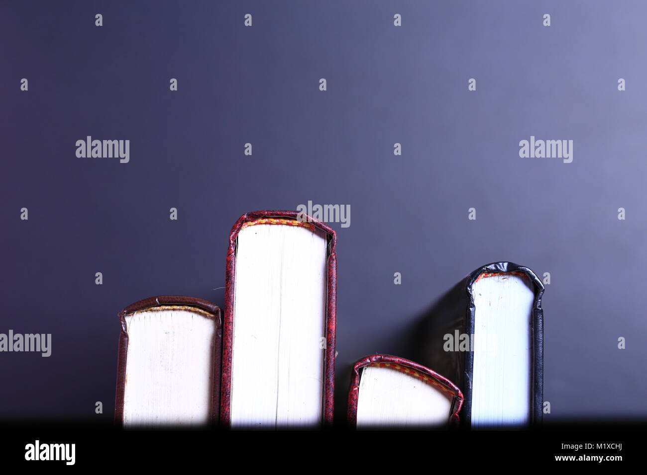 Stack of old books isolated on black background Stock Photo - Alamy