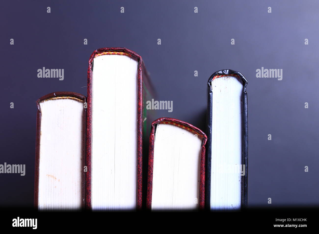 Stack of old books isolated on black background Stock Photo - Alamy