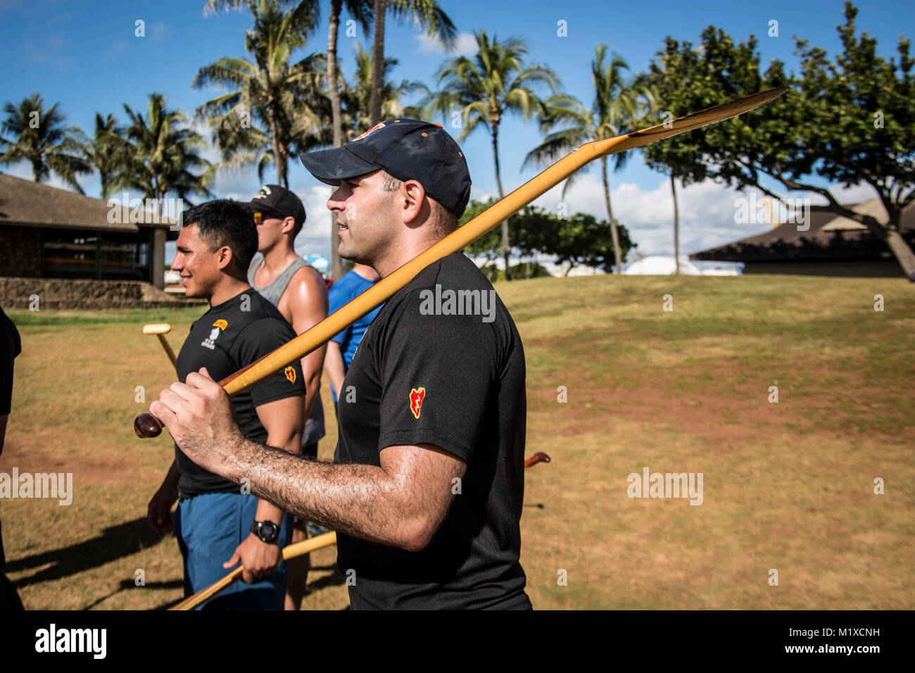 U.S. Army 1st. Lt. Pete Falcone, assigned to 1st Battalion, 27th Infantry Regiment, 2nd Infantry Brigade Combat Team, 25th Infantry Division listens to paddle instruction before the start of the team-building exercise in Keehi Lagoon, Honolulu, Hi., Jan. 30, 2018. In an effort to strengthen international relationships, United States Army Pacific hosted personnel from the British Army to participate in a team building exercise facilitating outrigger canoeing. (U.S. Army Stock Photo