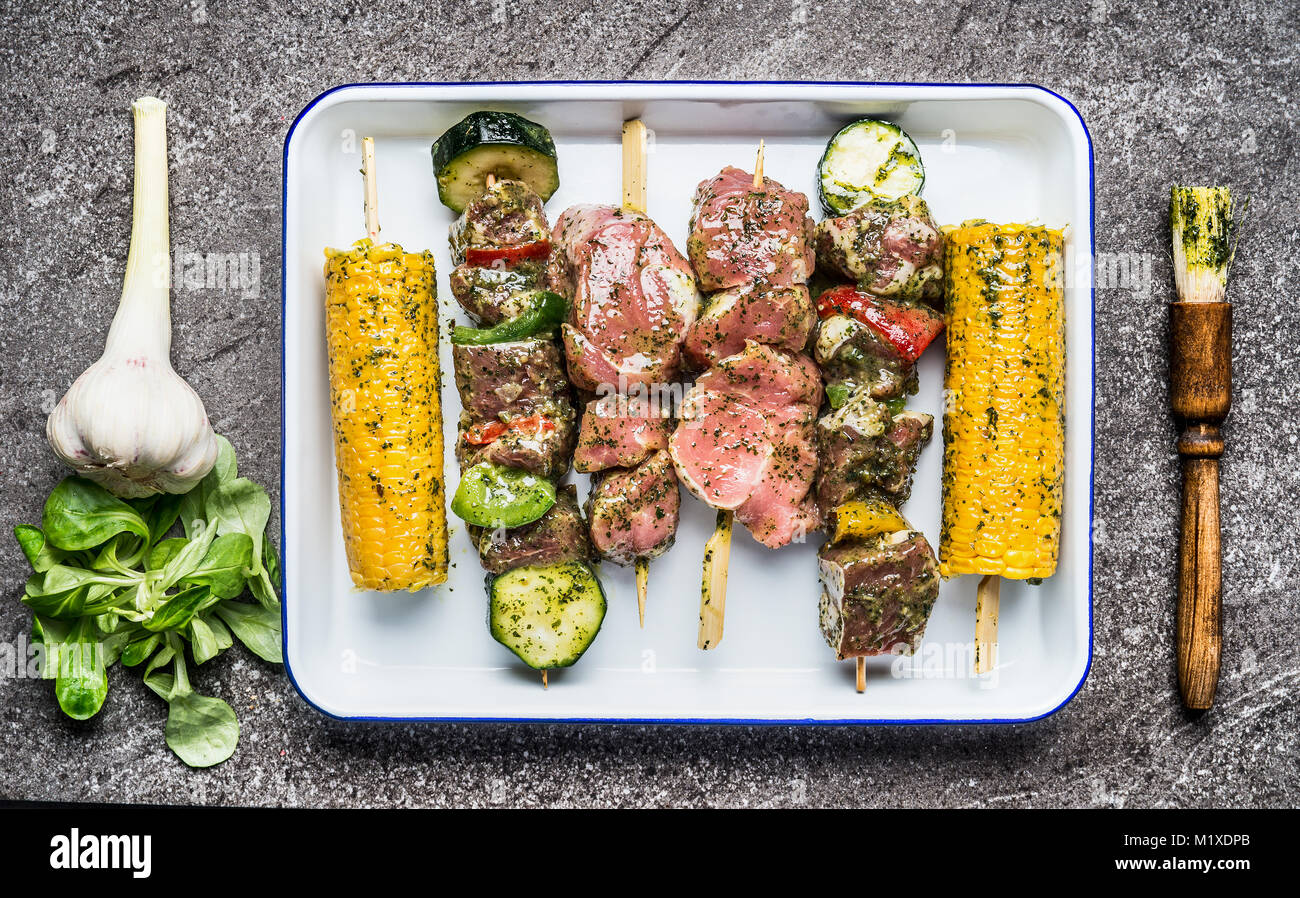 Tasty meat, vegetables and corn skewers in herbs marinate with fresh