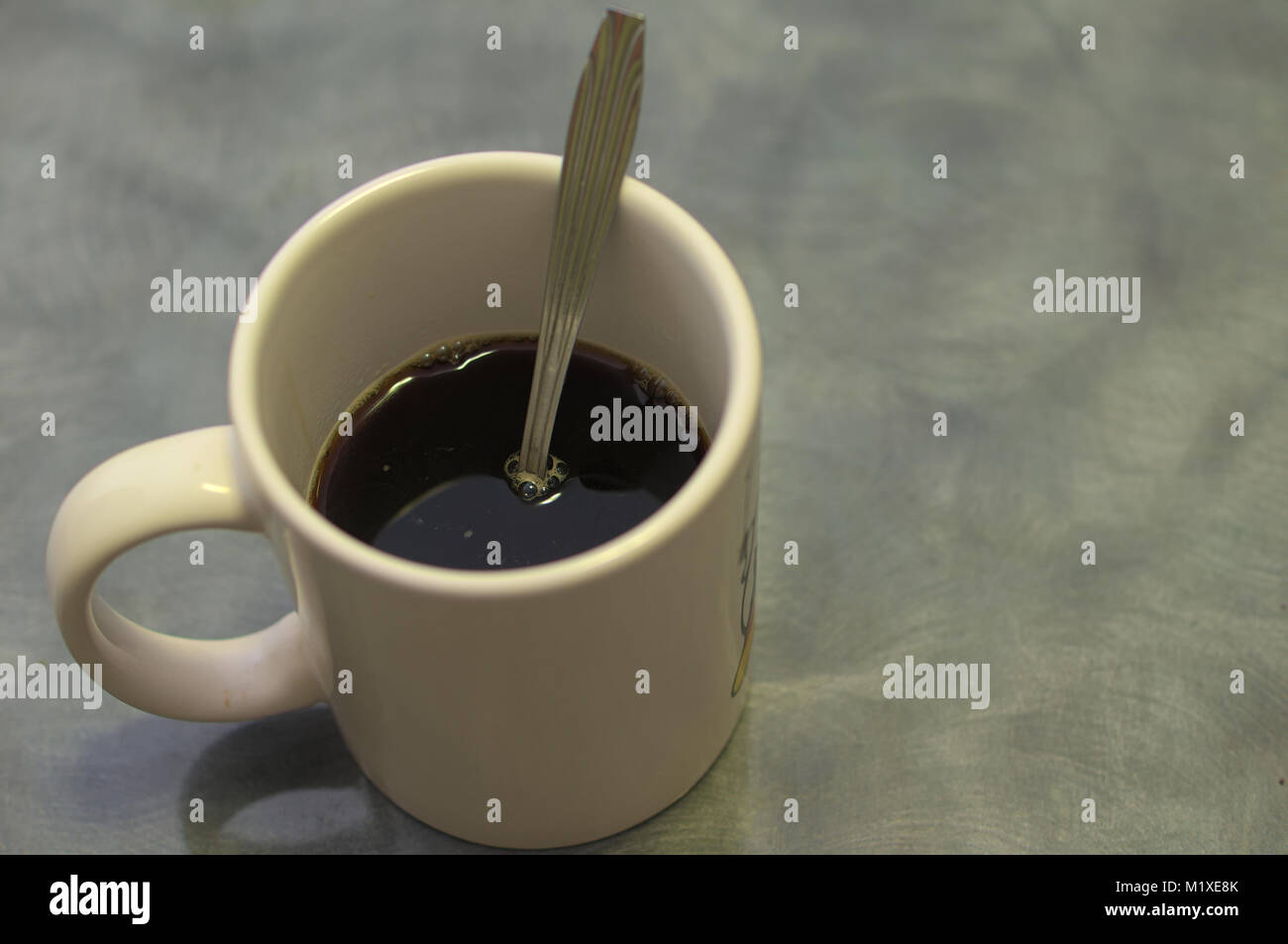 Ice coffee in glass mug with milk and cinnamon on wooden table in the  garden Stock Photo - Alamy