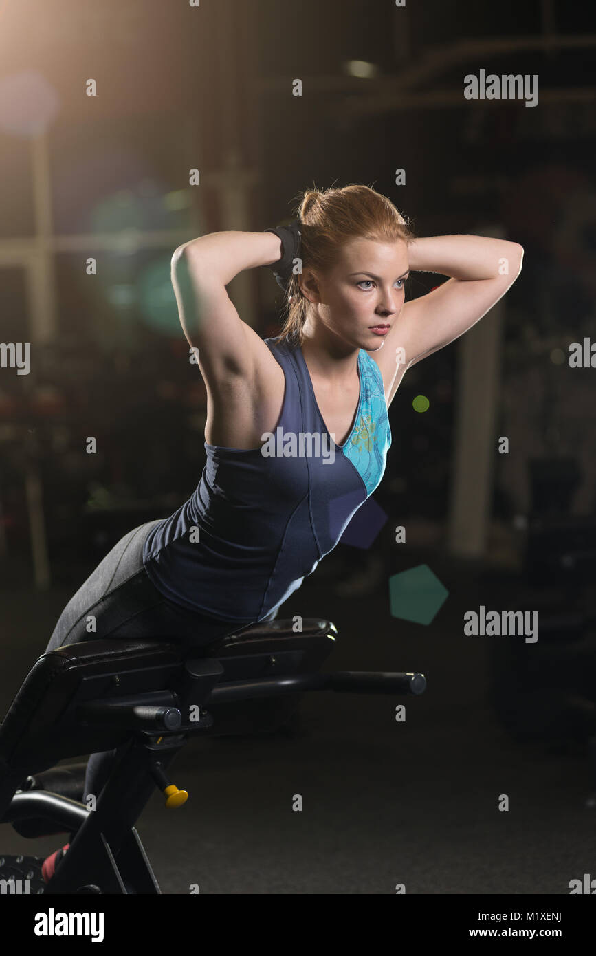 Woman doing strength exercises for abs muscles Stock Photo