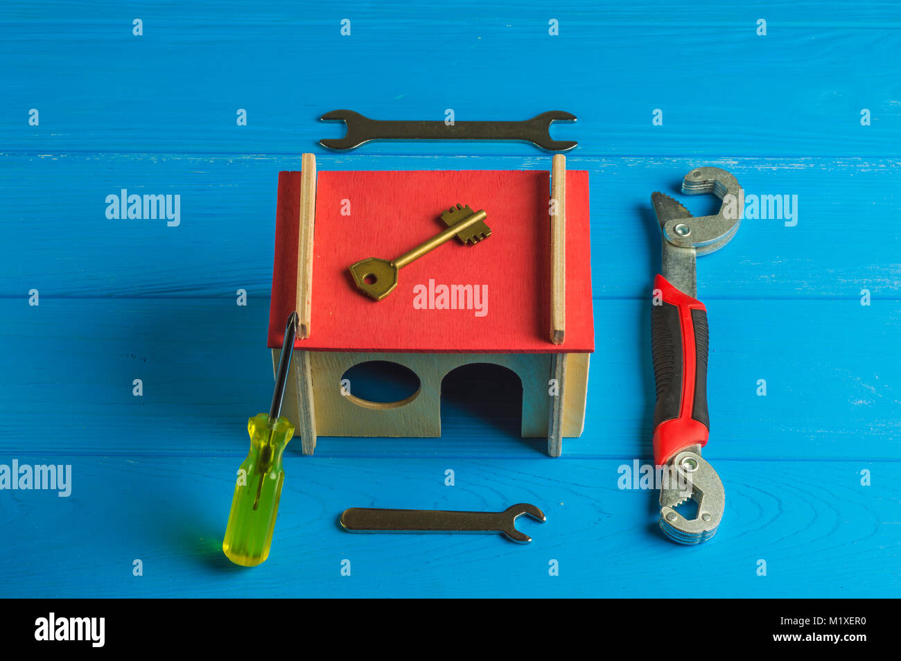 Repairing tools and model house on wooden background Stock Photo