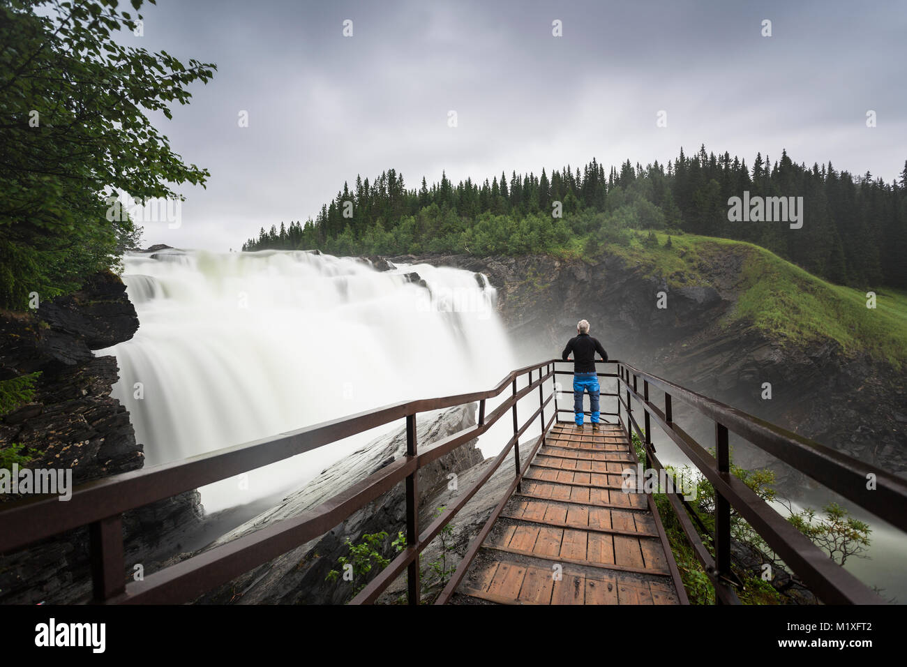 Man at lookout of waterfall in Jamtland, Sweden Stock Photo