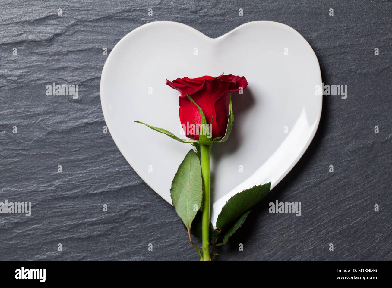 Valentines day table setting. Heart shaped plate with rose Stock Photo ...