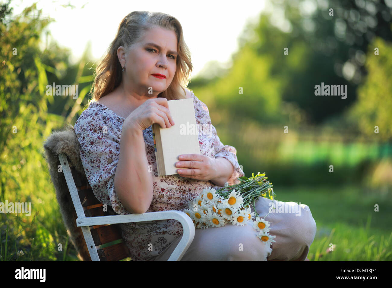 An elderly woman on the porch of a house Stock Photo - Alamy