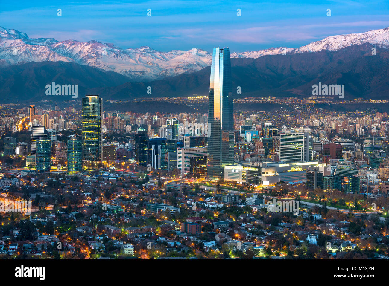 Panoramic view of Providencia and Las Condes districts with Costanera Center skyscraper, Titanium Tower and Los Andes Mountain Range, Santiago de Chil Stock Photo