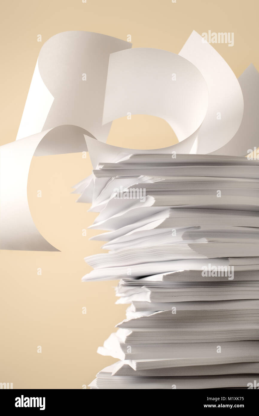Stack of Papers against a plain color background Stock Photo