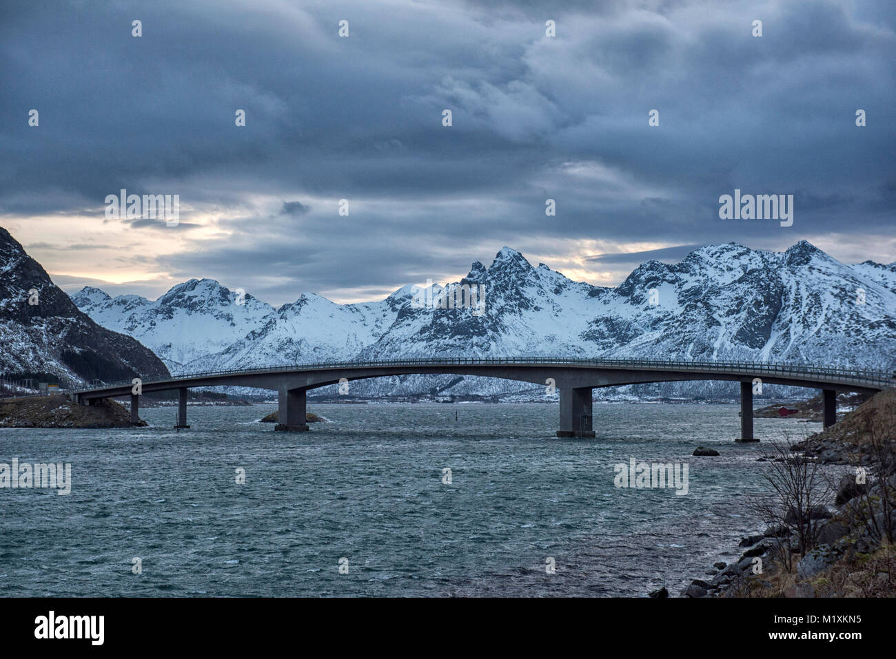 Bridge over a snow covered landscape in the Lofoten Islands of Norway Stock Photo