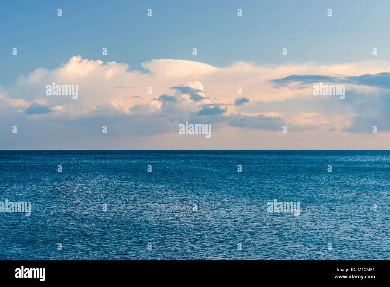 Looking out from Charlestown harbour wall to a blue hued abstract of sea and sky. Stock Photo