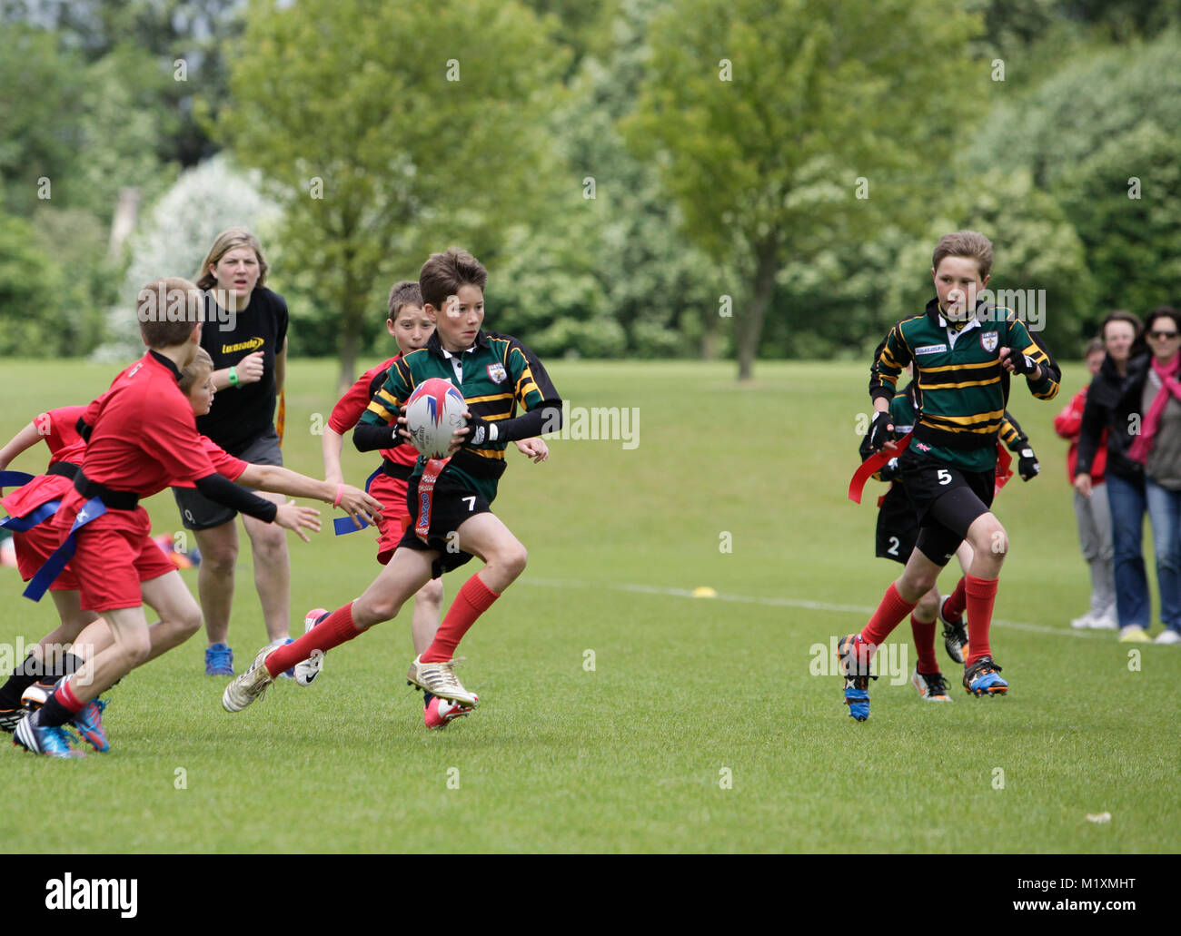 Girls and boys playing Tag Rugby in The midlands on a rainy Afternoon in  Spring Stock Photo - Alamy