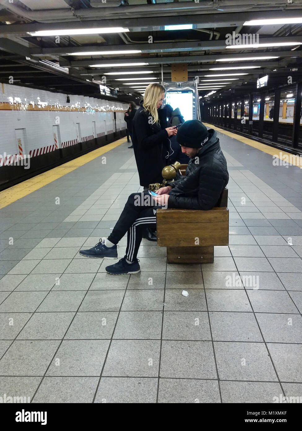 Distracted woman in subway station hi-res stock photography and images ...