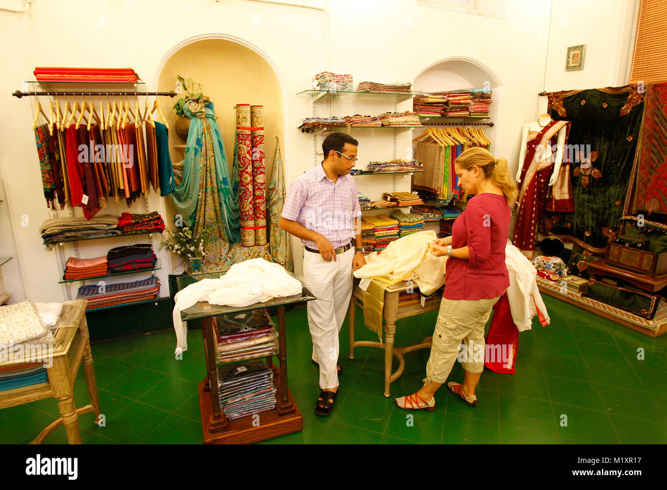 Tourist trying typical indian clothes at a luxury fabric shop, Mysore