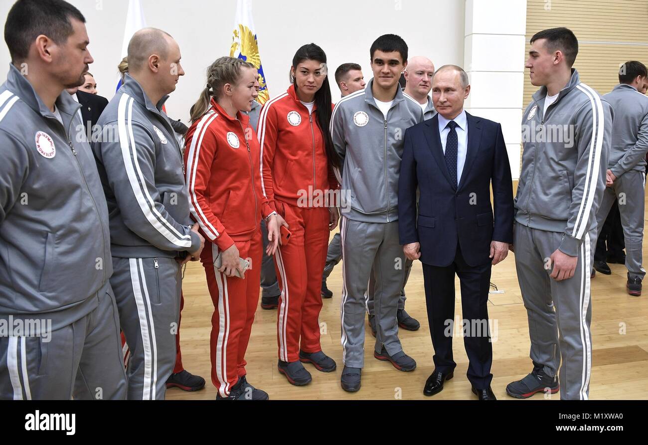 Russian President Vladimir Putin chats with athletes competing in the PyeongChang Olympic Winter Games January 31, 2018 in Novo-Ogaryovo, Moscow, Russia. Stock Photo