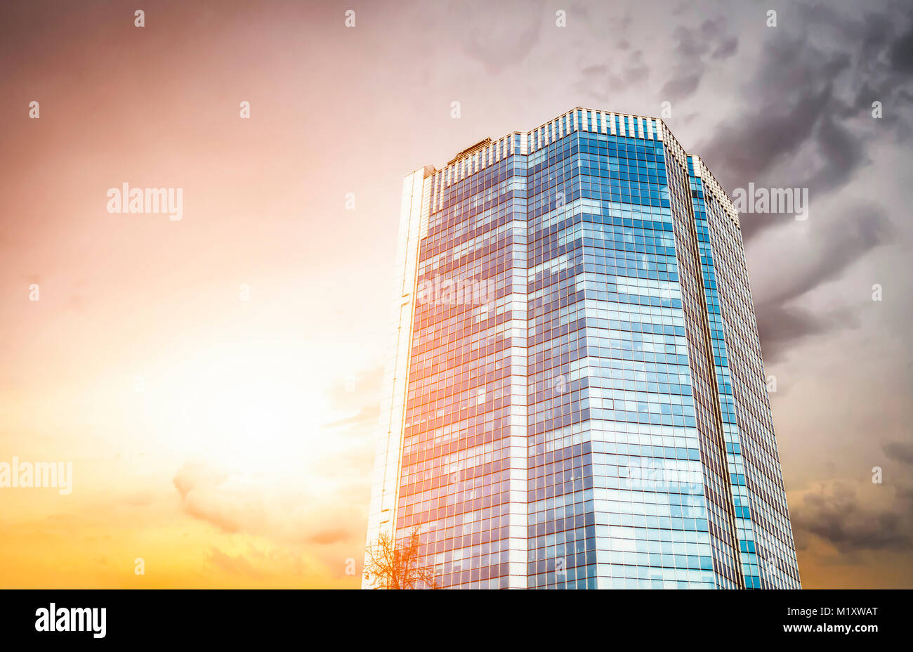 Modern high rise building of glass against the evening sky Stock Photo ...