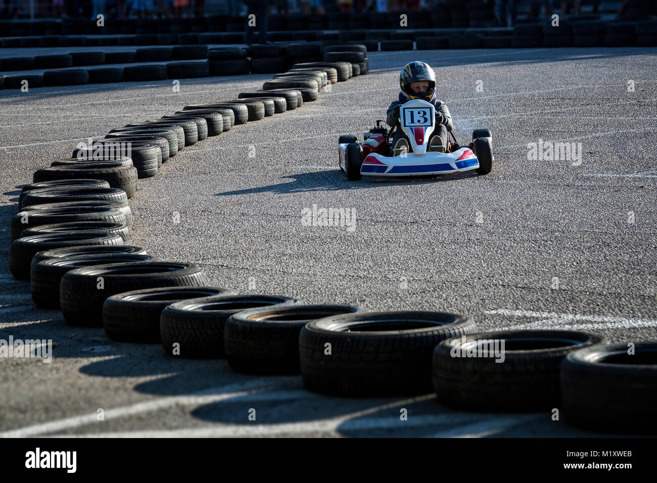 Driver In Go Kart Participate In Outdoor Kart Race Stock Photo