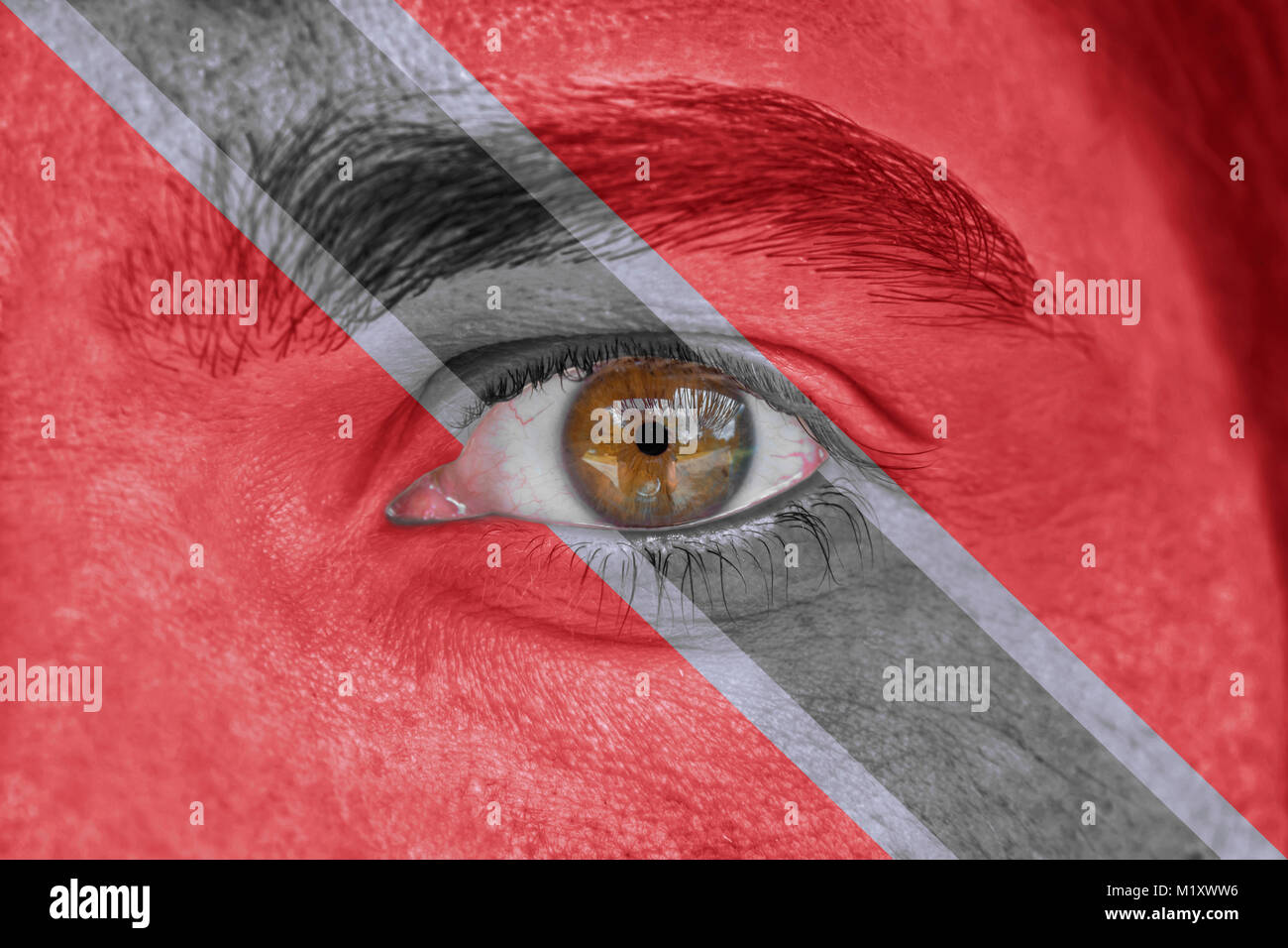 Human face and eye painted with flag of Trinidad and Tobago Stock Photo