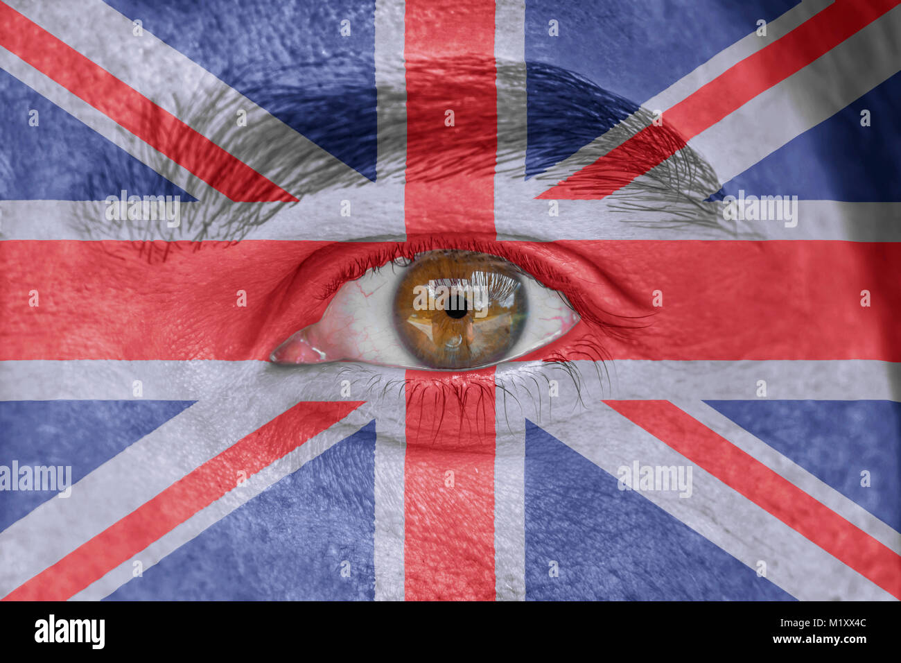 Human face and eye painted with flag of United Kingdom Stock Photo