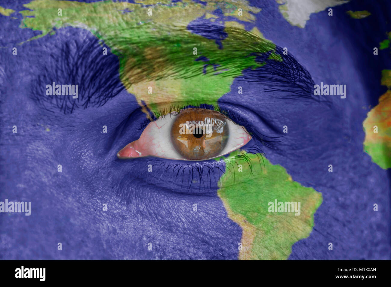 Human face and eye painted with South and North America space geography map Stock Photo