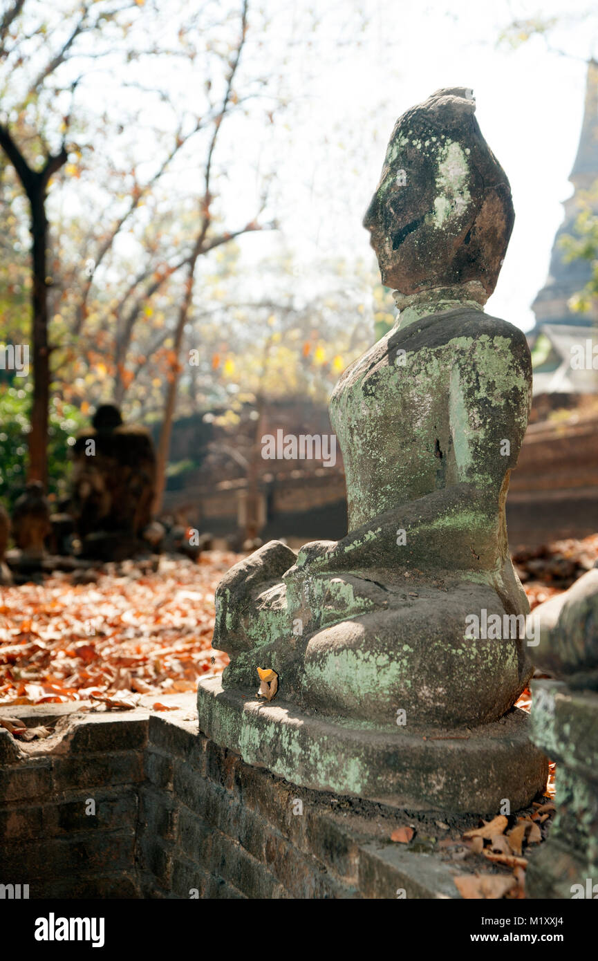 Ancient outdoor Buddhas field of broken sculpture in Wat Umong Suan Puthatham.The temple is a 700 year was built in 1297 in Chiang Mai city, Thailand. Stock Photo