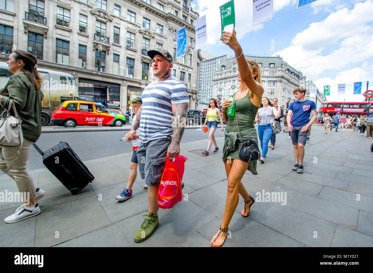 London, England, UK. People in Regent Street woman taking a selfie