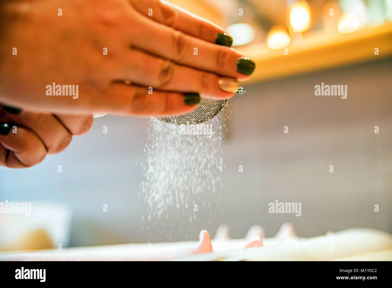 Sifting sugar powder on meringue cake Stock Photo Alamy