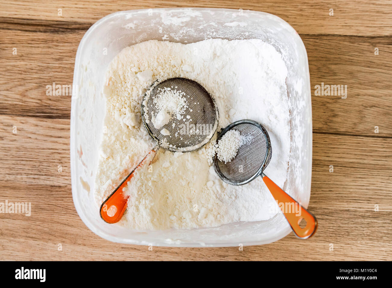 Sugar powder and two sifters in container Stock Photo Alamy