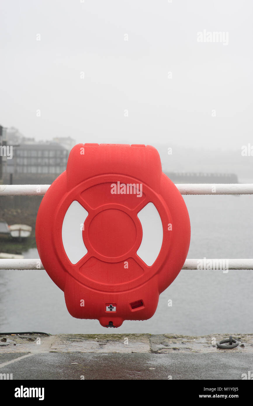 Life boye at the Price of Wales Pier on a foggy morning in Falmouth, Cornwall. Stock Photo