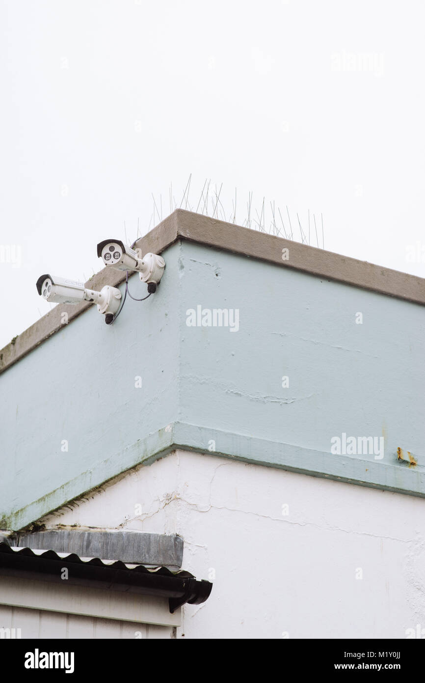 Two CCTV Cameras on the corner of a building on the Price of Wales Pier Falmouth, Cornwall. Stock Photo