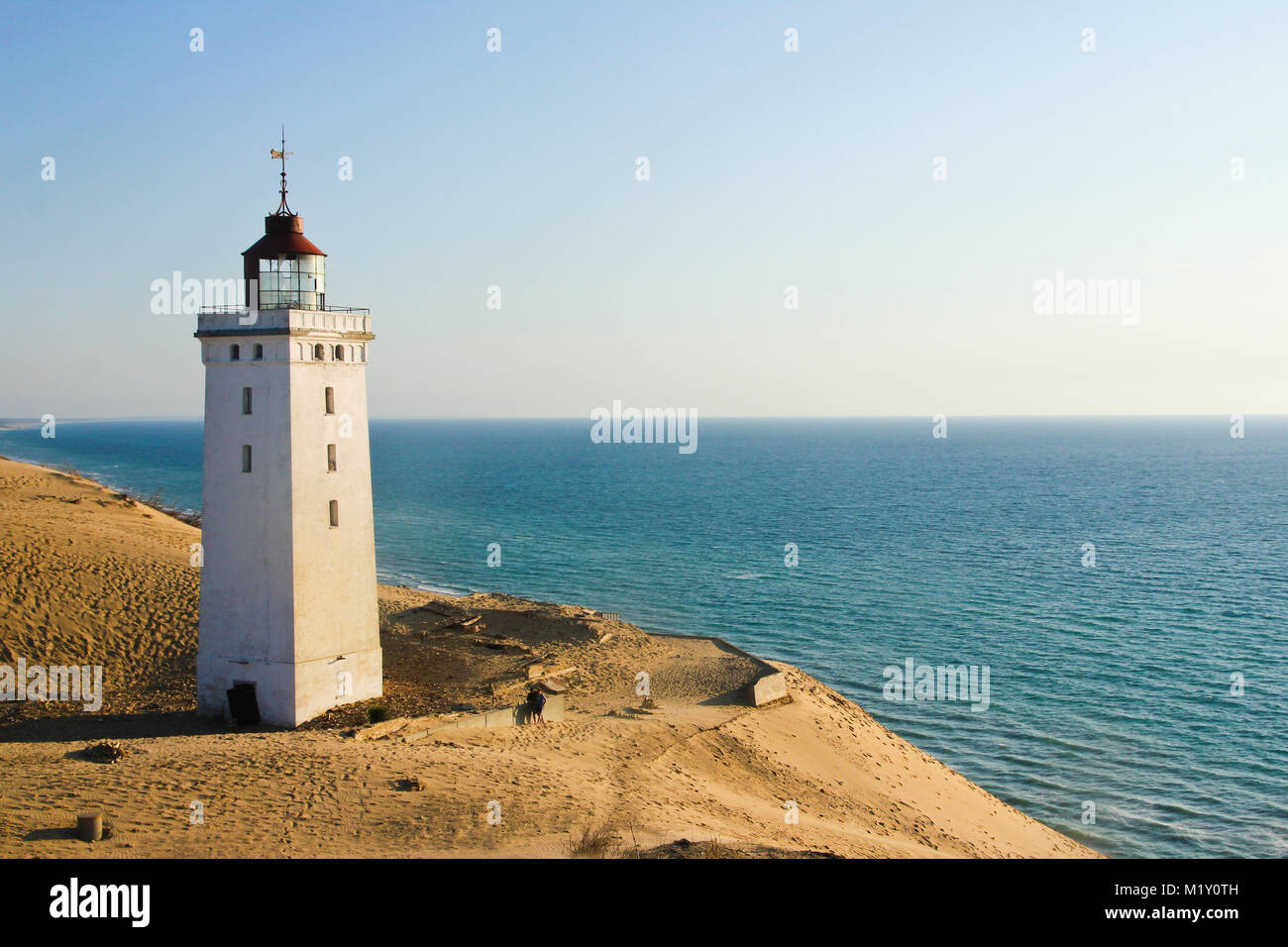 A lonely abandoned lighthouse waiting for the sea to come and for its ...