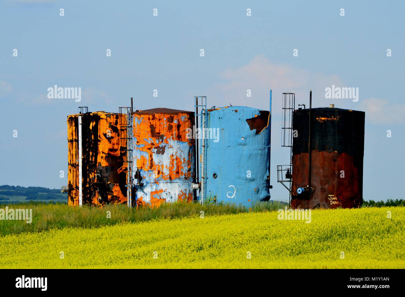 Threatened environment by rusty prarie oiltanks in Montana Stock Photo