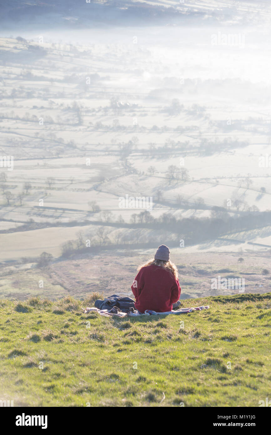 UK, Derbyshire, a walker admiring the view over Hope Valley from Mam Tor. Stock Photo