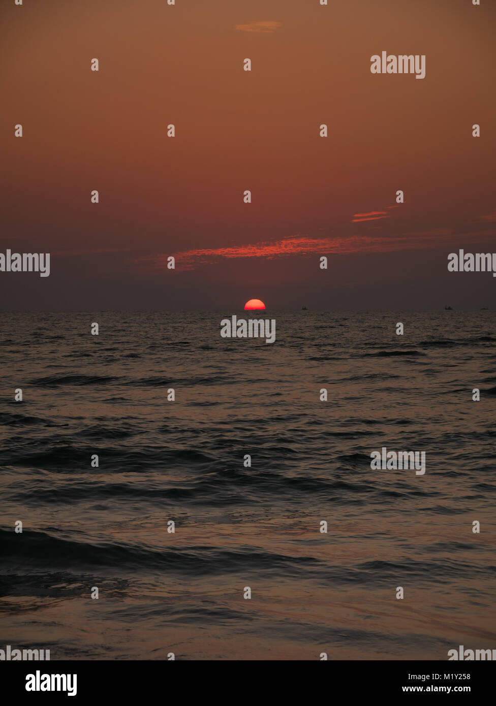 Colorful sunrise sunset over the sea ocean waves Stock Photo - Alamy