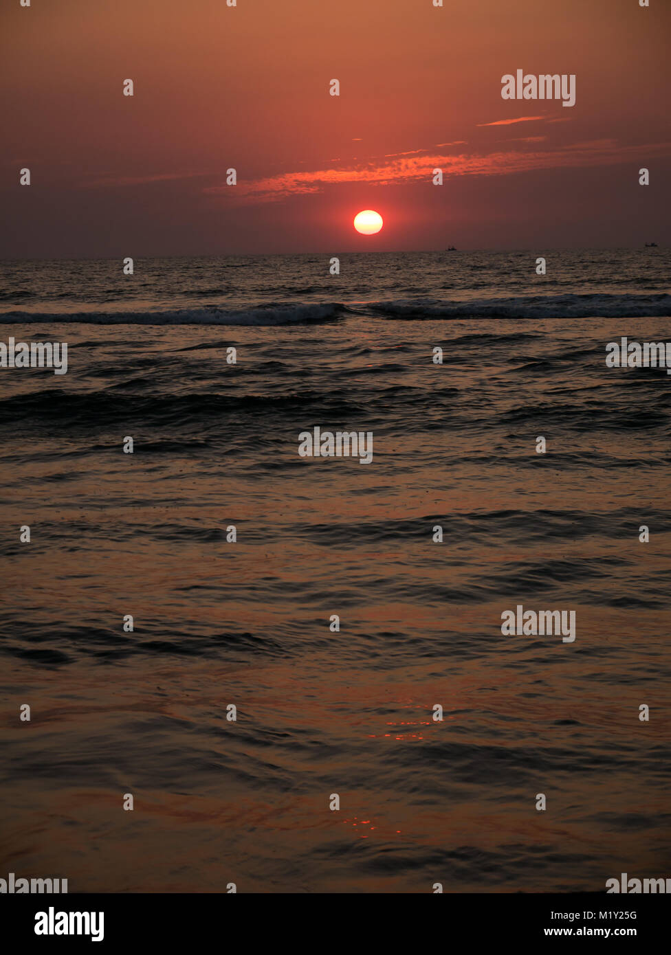 Colorful sunrise sunset over the sea ocean waves Stock Photo - Alamy