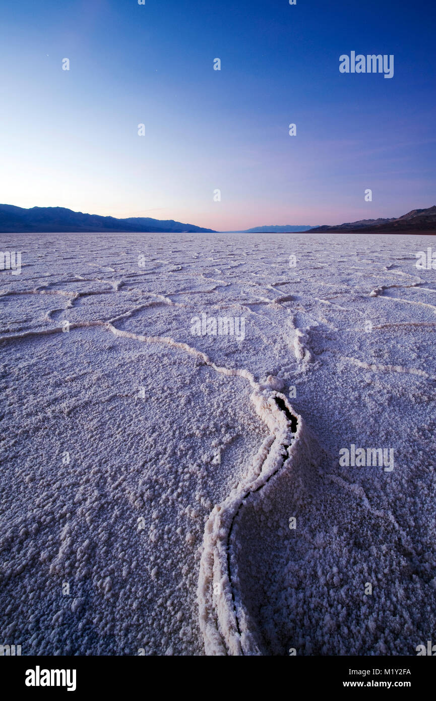 Sunset over Badwater Basin in Death Valley National Park, California.  Badwater Basin is the lowest point in North America at an elevation of 282 feet Stock Photo