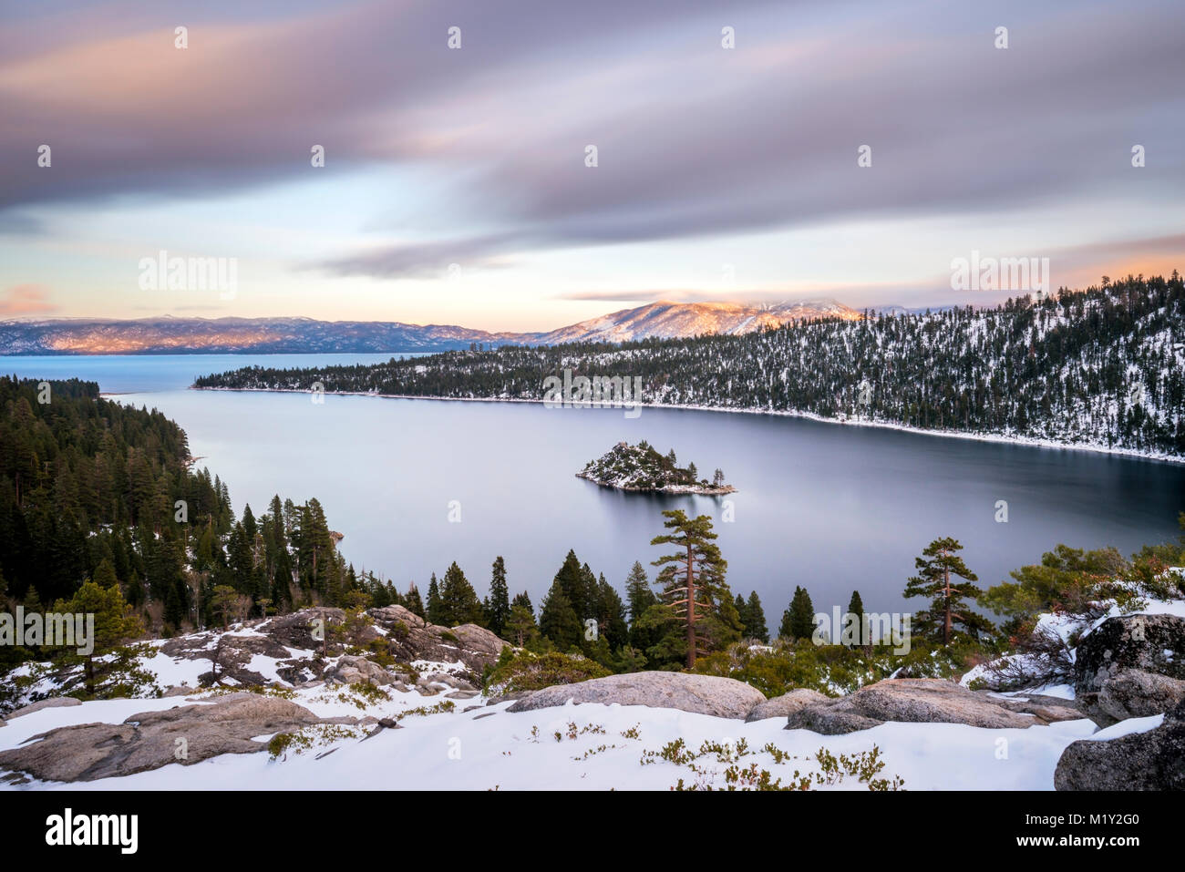 Beautiful clouds stream over Emerald Bay in the winter at sunset near South Lake Tahoe, California. Stock Photo