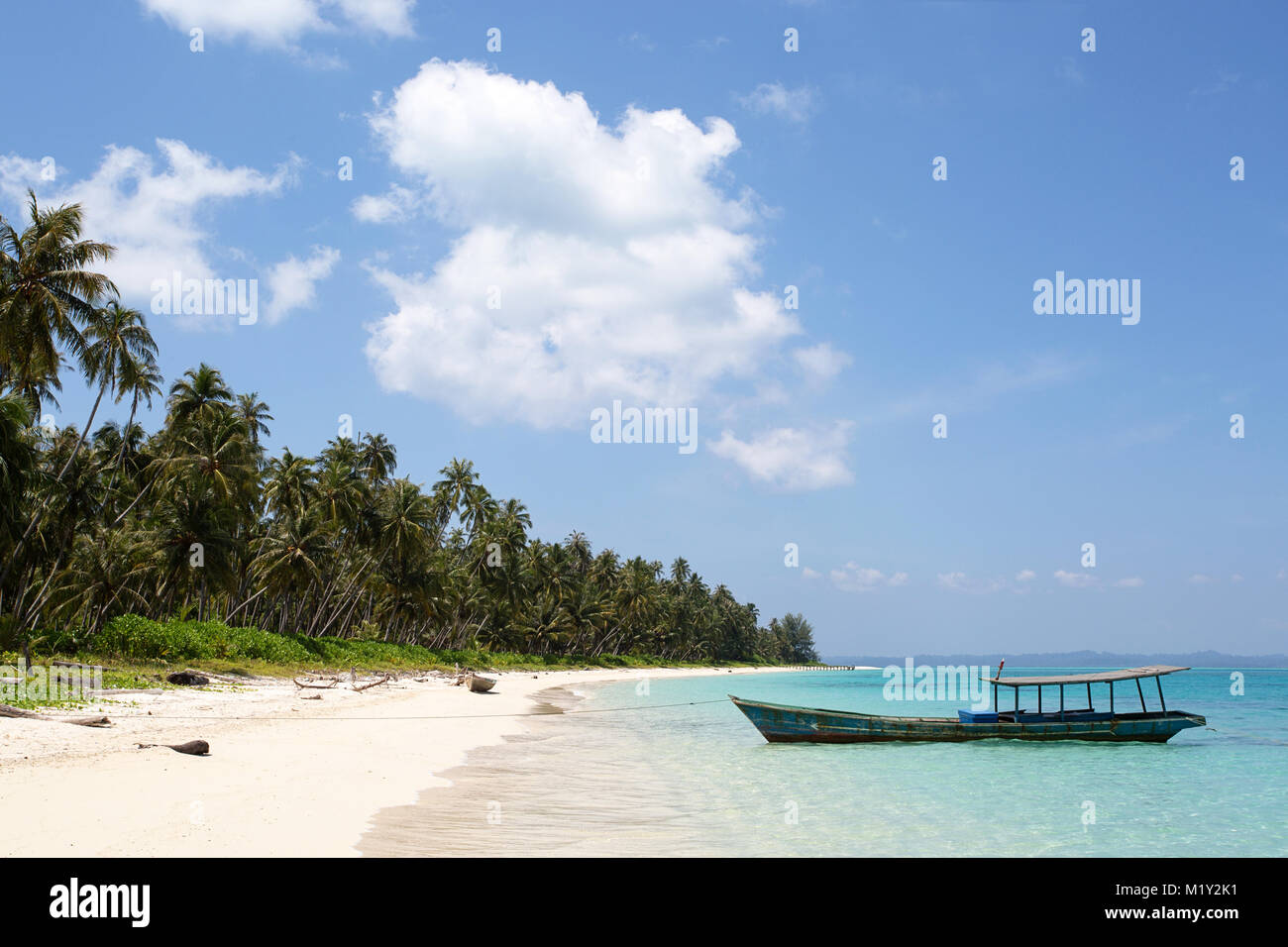Beautiful tropical beach with crystal clear turquoise water and traditional boat Stock Photo