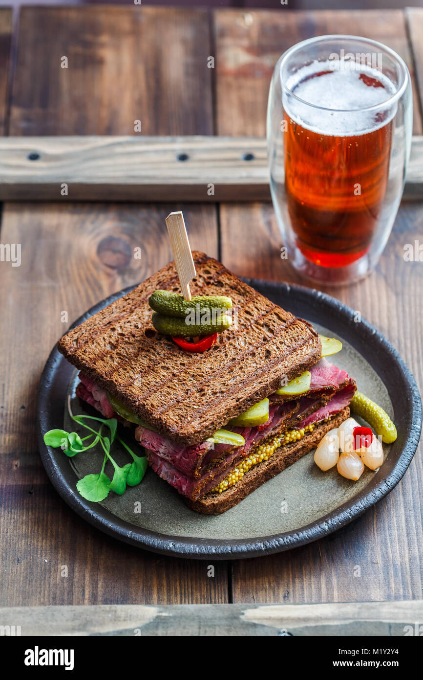 Pastrami sandwich with mustard and pickle and beer Stock Photo Alamy
