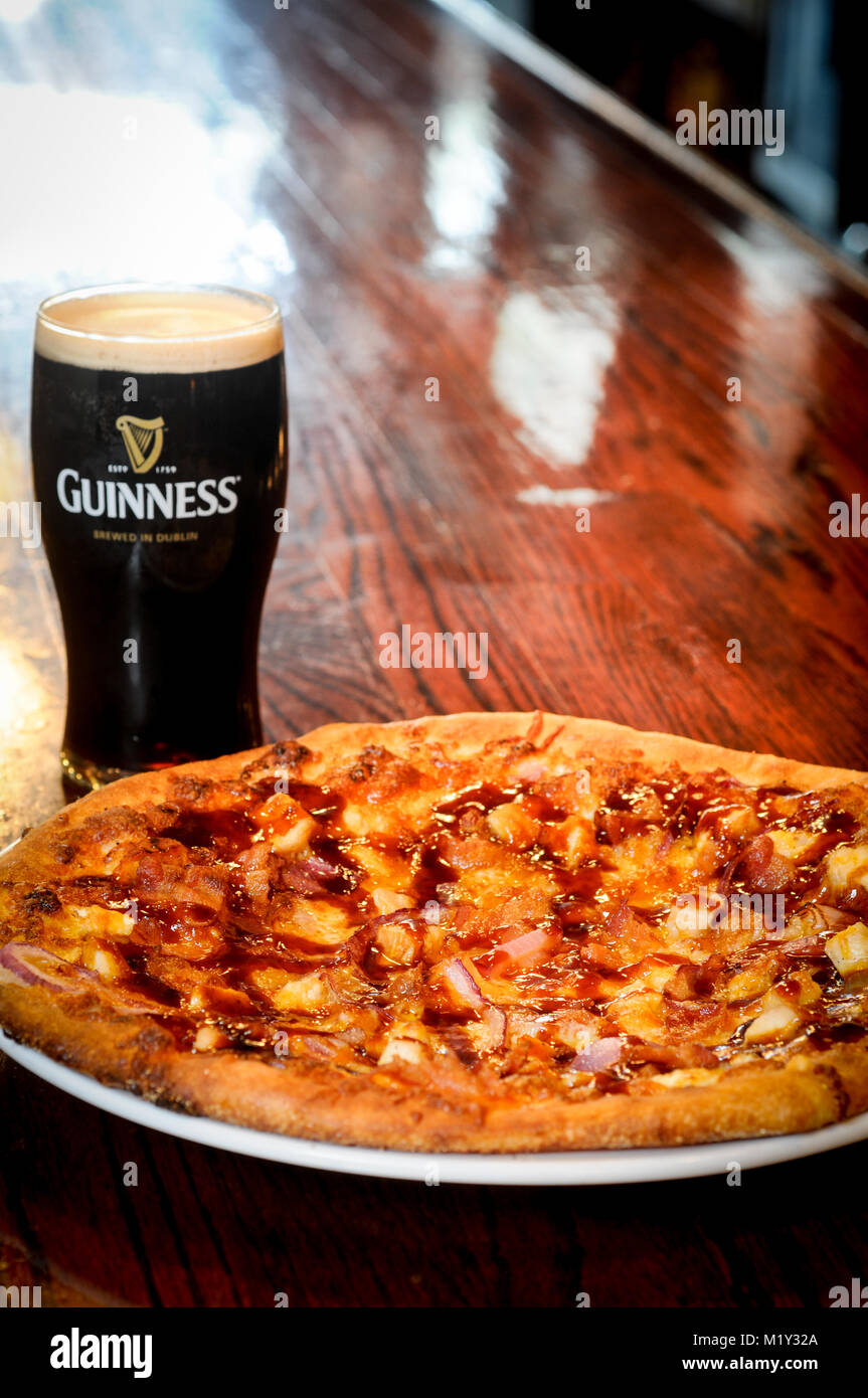 Pizza with a Guinness beer Stock Photo Alamy