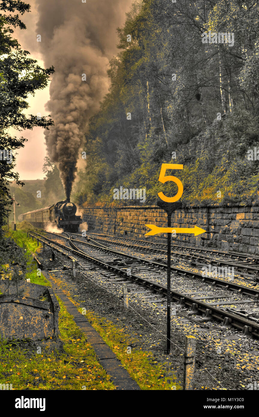 Steam train approaching Goathland station with an impressive smoke stack. (Processed as an HDR image). Stock Photo