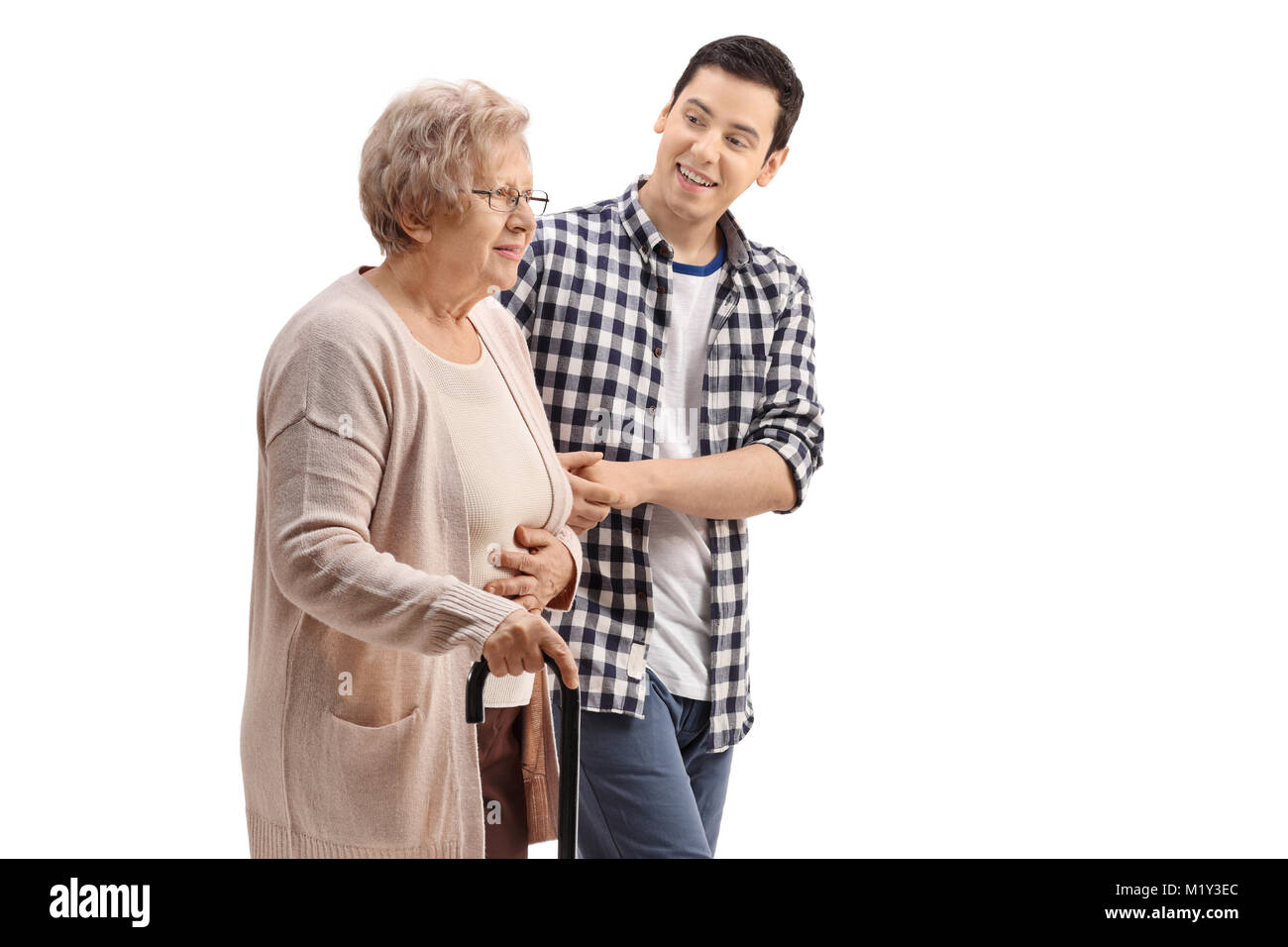 Young man holding an elderly woman with a walking cane isolated on white background Stock Photo