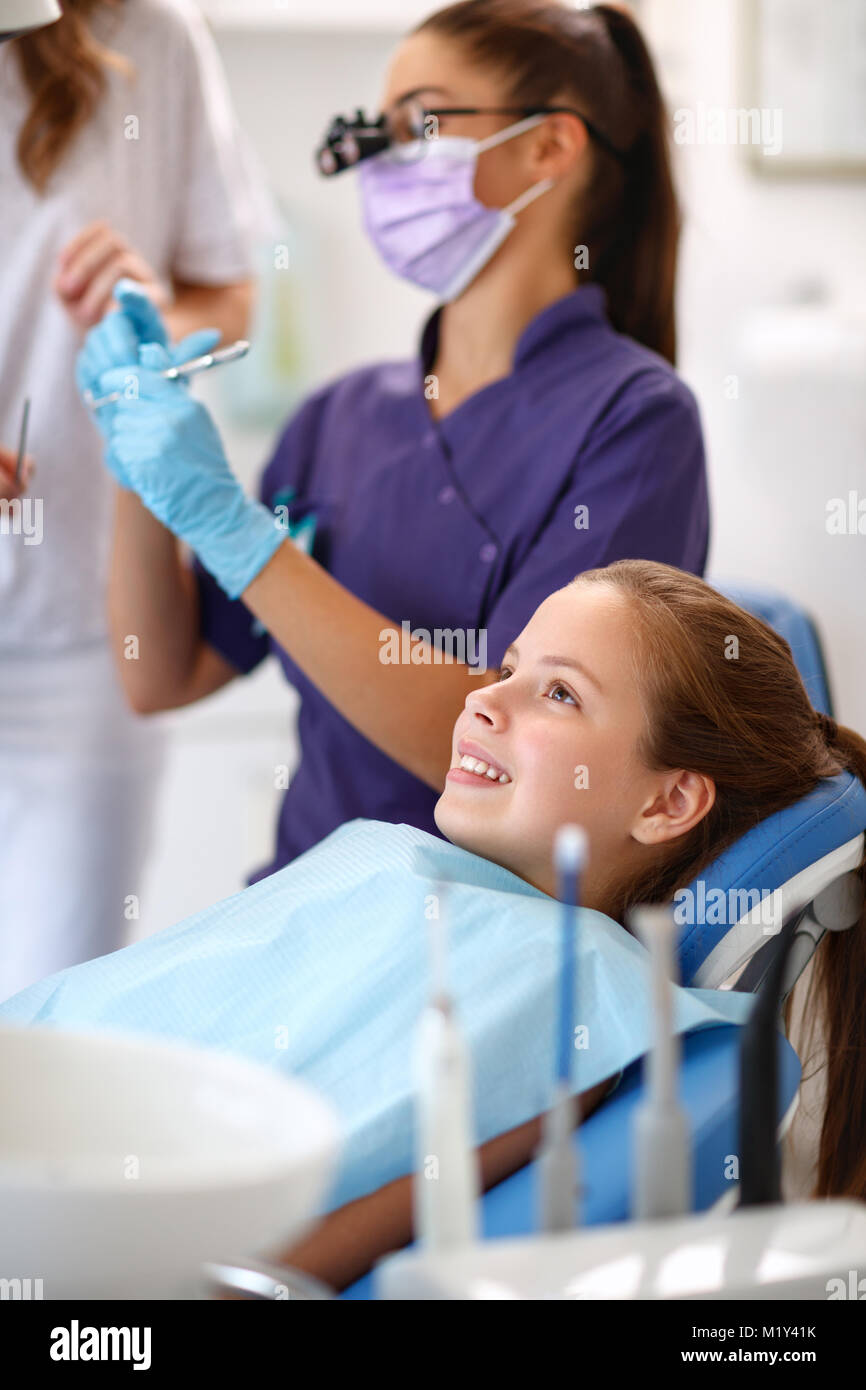 Cute girl on dental chair in in dental ambulant Stock Photo