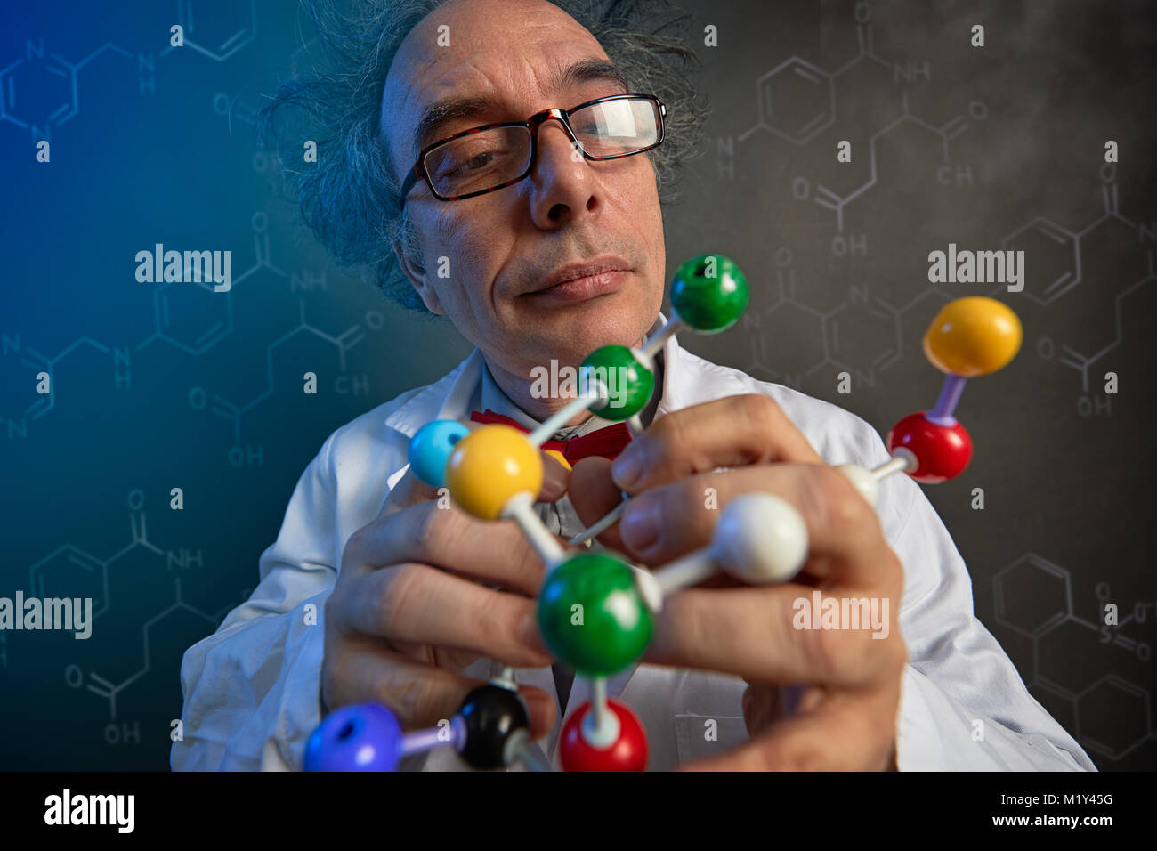university scientist examining the building blocks of model molecules, fun look Stock Photo