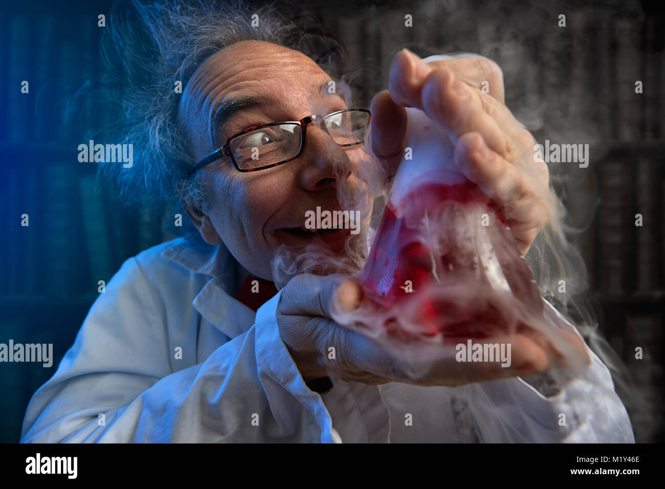 deranged scientist obsessed looking at his  experiments Stock Photo