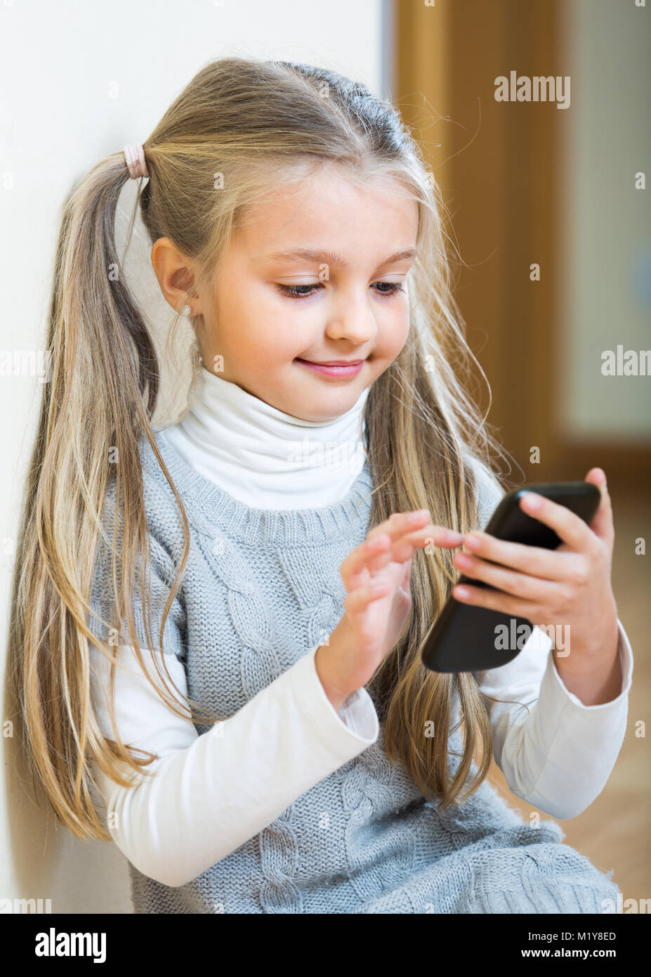 Portrait of cute little girl with ponytails having fun with Stock