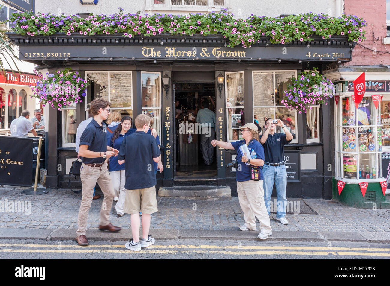 Tourists outside the entrance to The Horse and Groom public house, Windsor, Berkshire, England, GB, UK Stock Photo