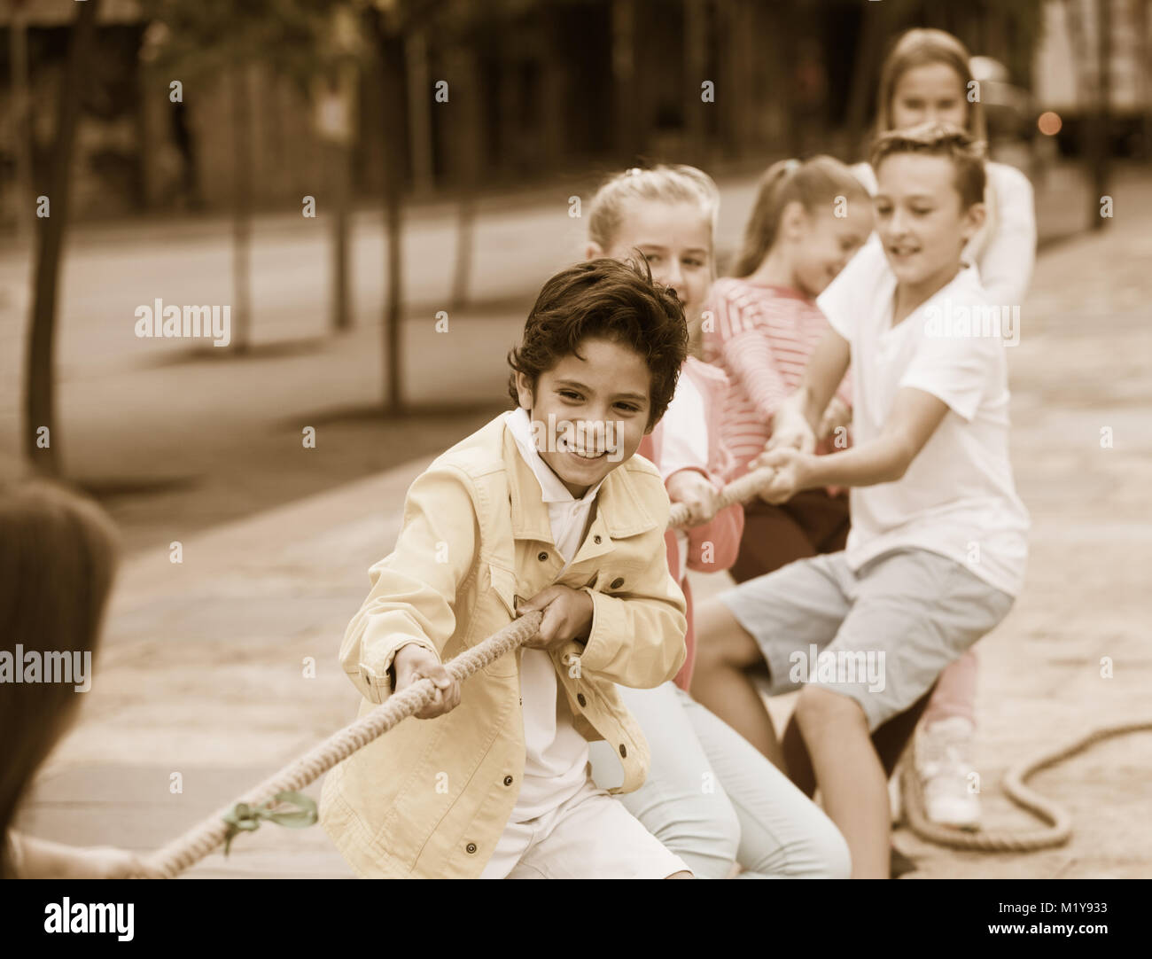 Children are pulling rope in the park Stock Photo - Alamy