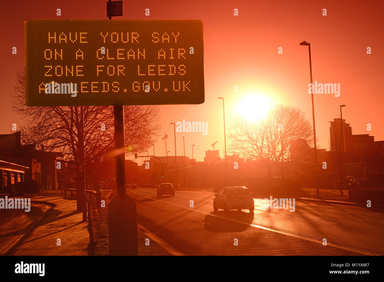 traffic passing digital advert asking for public consultation on a clean air zone for leeds city centre yorkshire united kingdom Stock Photo