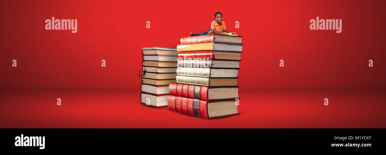 Boy reading on a pile of books with red background Stock Photo - Alamy